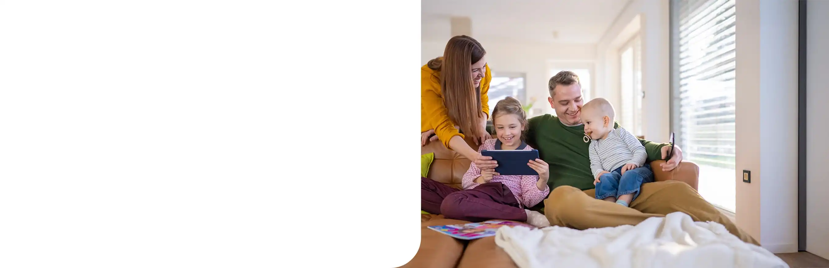 young caucasian family relaxing on sofa using tablet