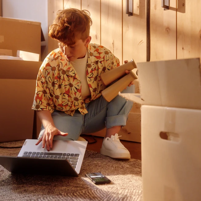 A Girl packing things and checking for new house interent availability and plans.