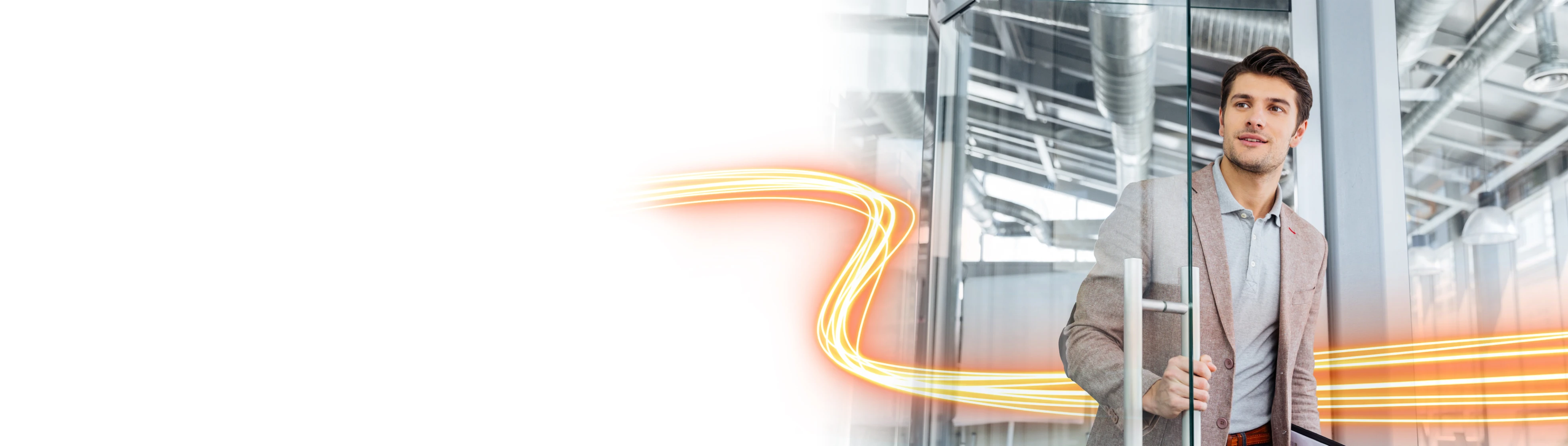 Business professional entering a modern glass office building