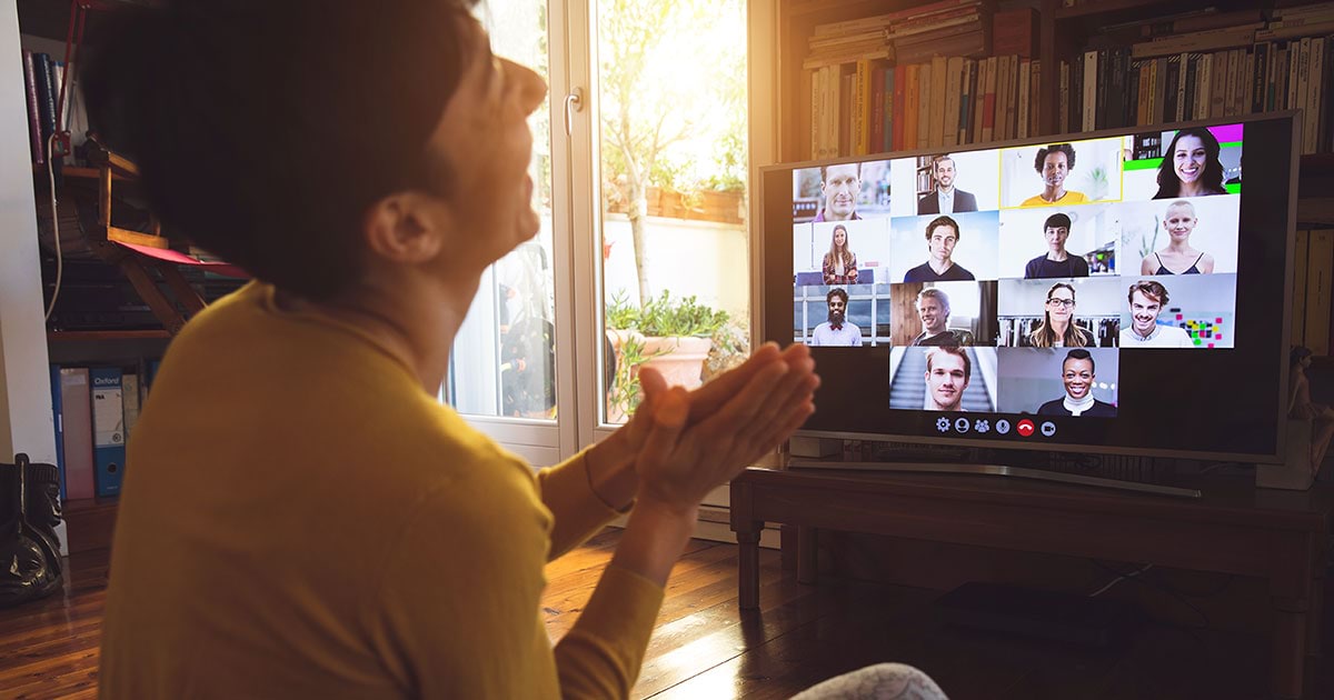 A man laughs during a video meeting