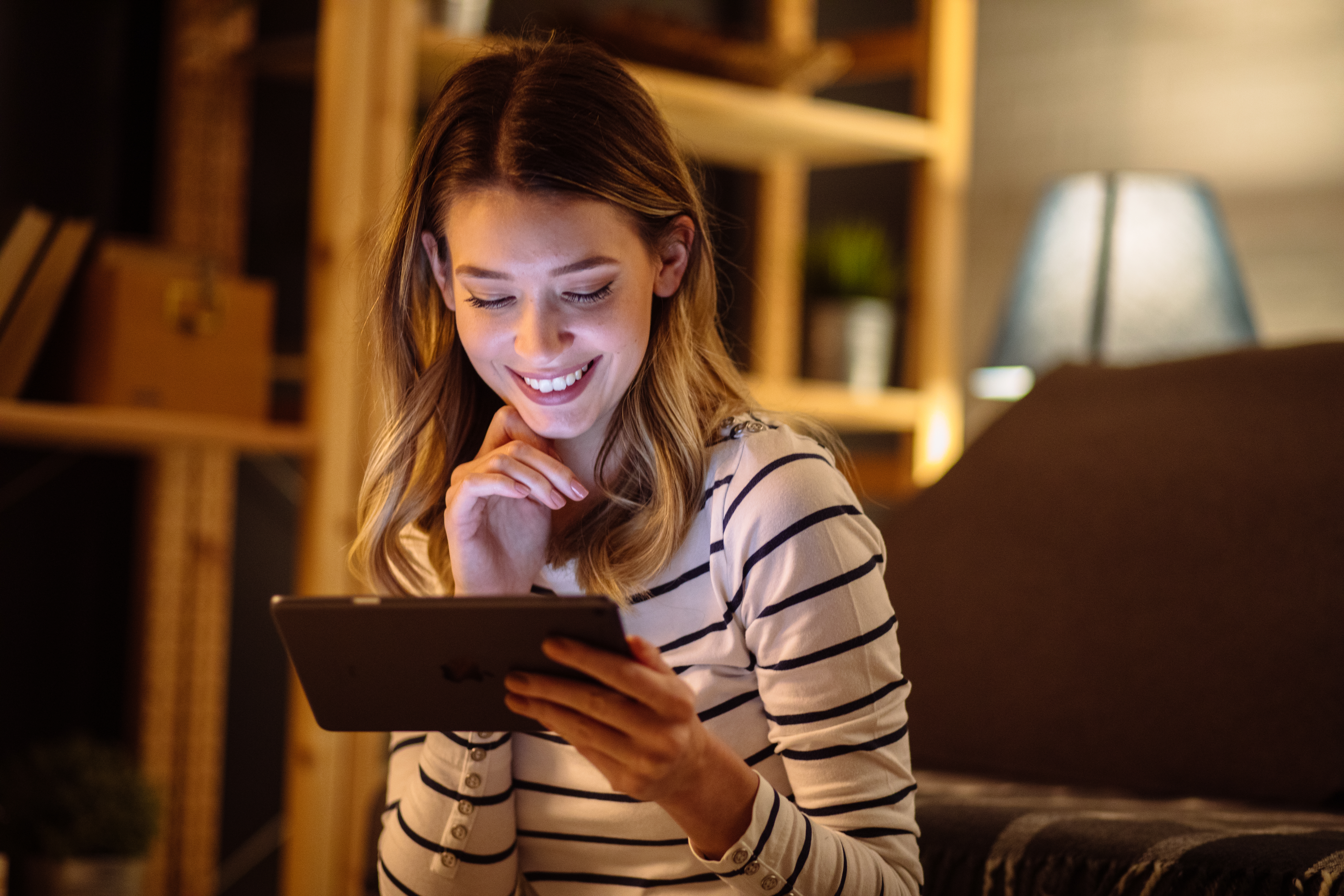 A person streams video content on a tablet