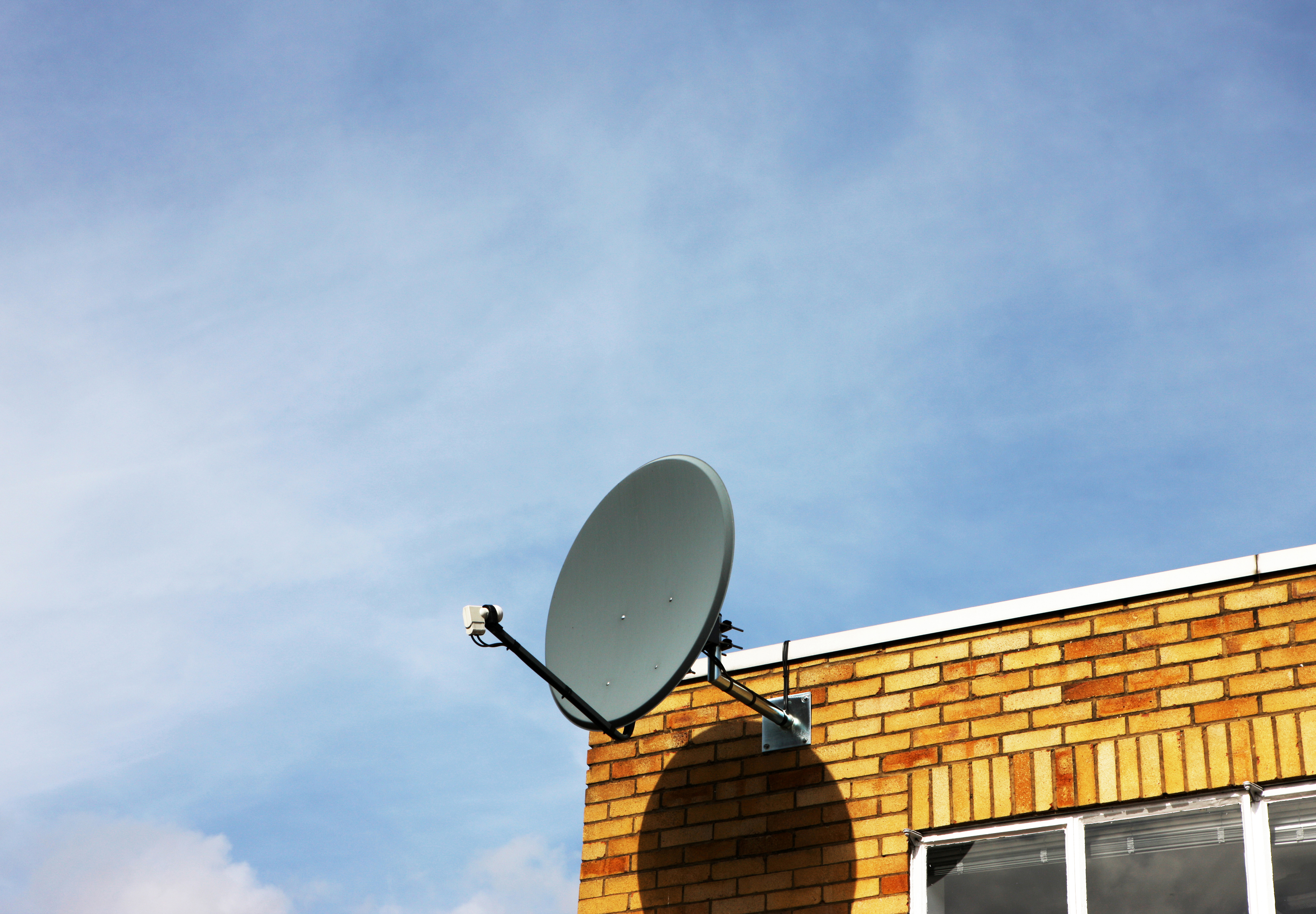 A satellite dish on top of a building.